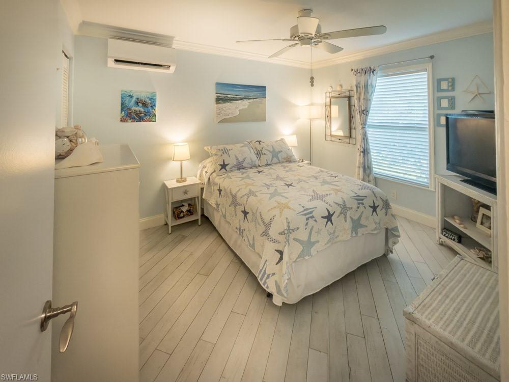 8382 Butternut Road Fort Myers, FL 33967 - Photo 14 of 19 a bedroom with a bed and a flat tv screen on dresser