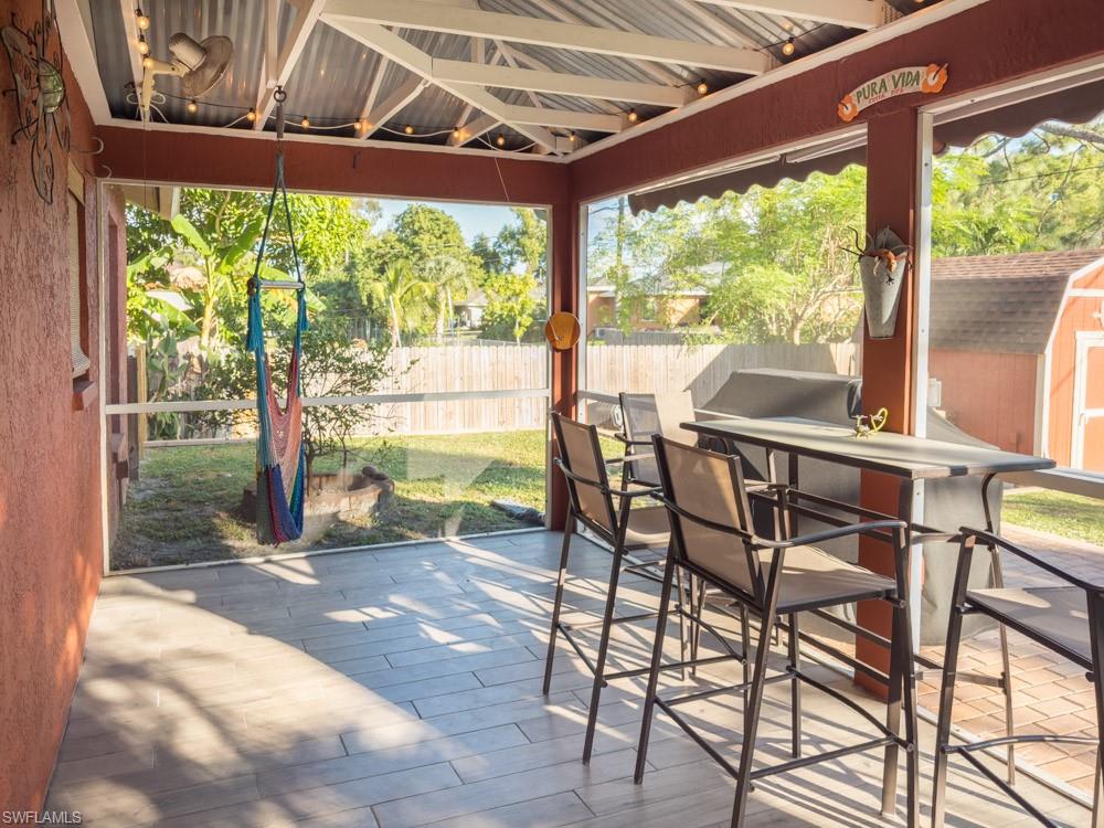 8382 Butternut Road Fort Myers, FL 33967 - Photo 16 of 19 a view of a patio with a table chairs and wooden fence