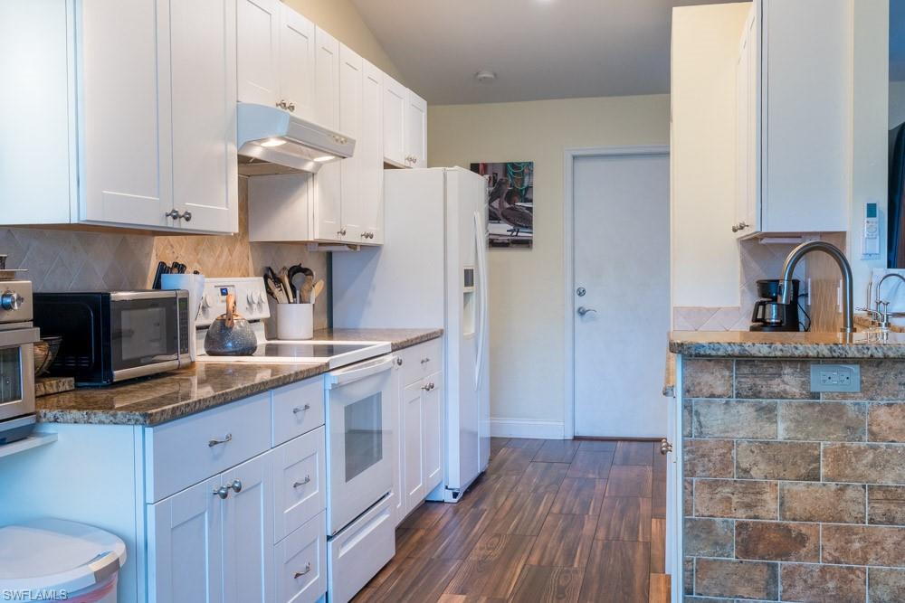 8382 Butternut Road Fort Myers, FL 33967 - Photo 6 of 19 a kitchen with a sink dishwasher a refrigerator and cabinets with wooden floor