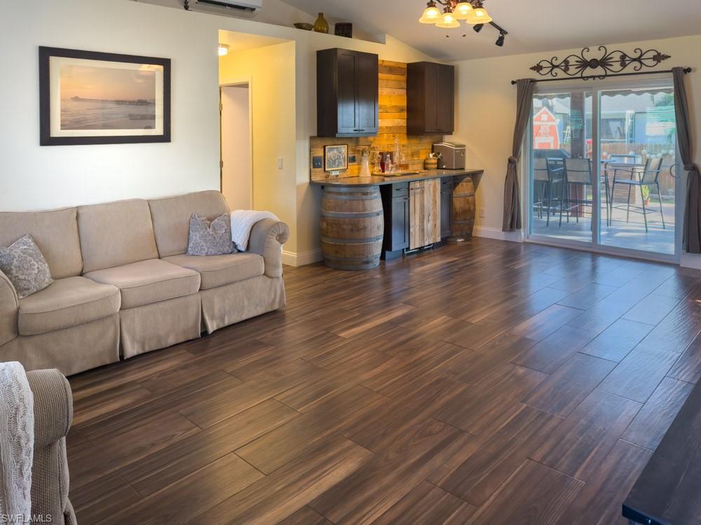 8382 Butternut Road Fort Myers, FL 33967 - Photo 7 of 19 a living room with couches and kitchen view with wooden floor