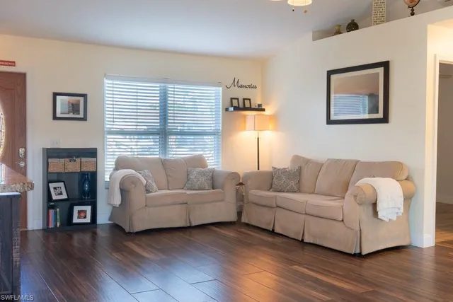 a living room with fireplace furniture and a wooden floor