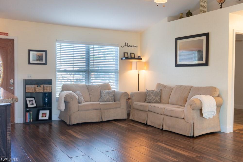 8382 Butternut Road Fort Myers, FL 33967 - Photo 8 of 19 a living room with fireplace furniture and a wooden floor