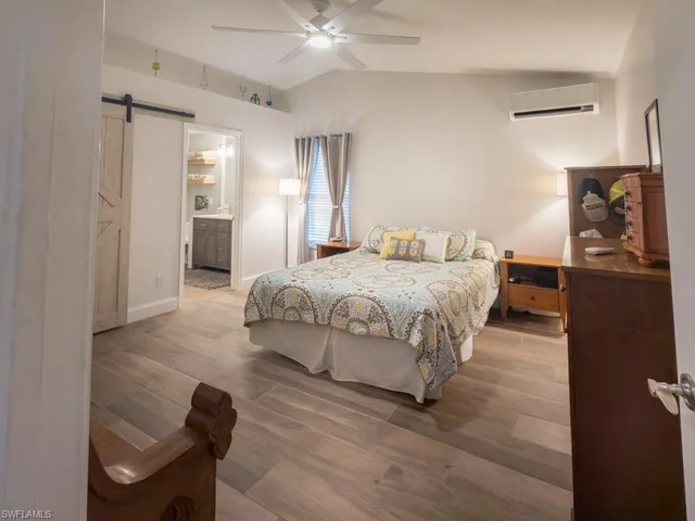 a bedroom with a bed and wooden floor