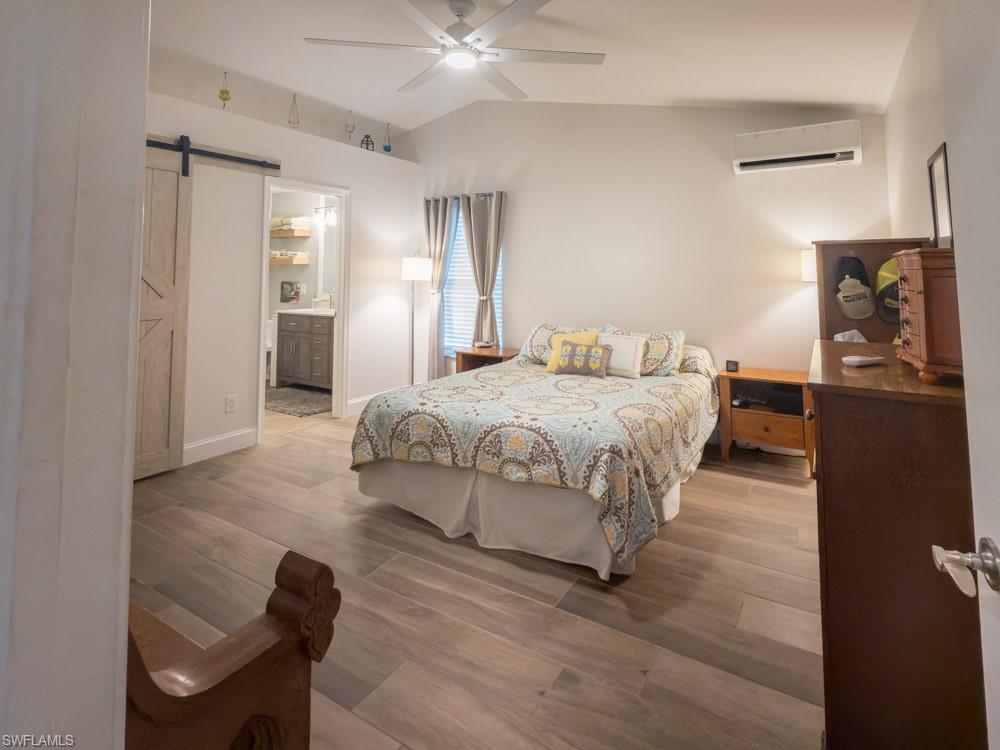 8382 Butternut Road Fort Myers, FL 33967 - Photo 9 of 19 a bedroom with a bed and wooden floor