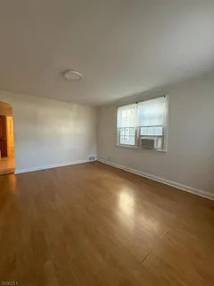 an empty room with a empty space and windows