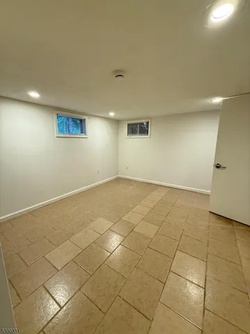 an empty room with white walls and tiles