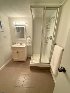 a bathroom with a tub sink and mirror