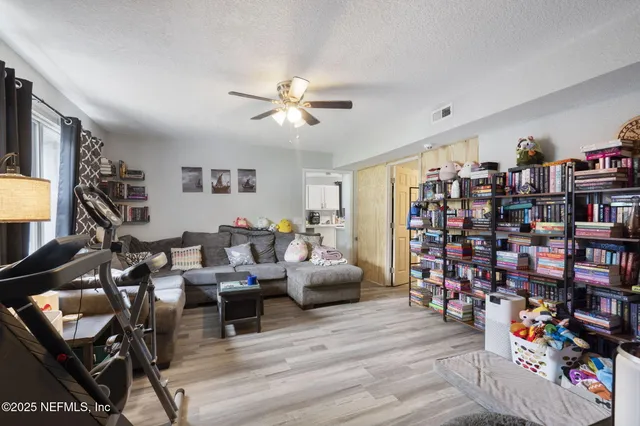a living room with lots of furniture and a book shelf