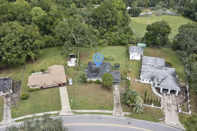 a house view with swimming pool and trees in the background