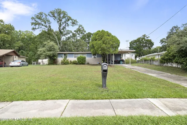 a view of a field with trees