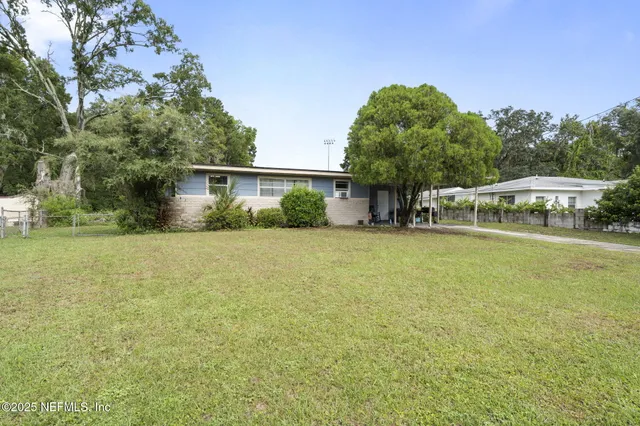 a backyard of a house with table and chairs
