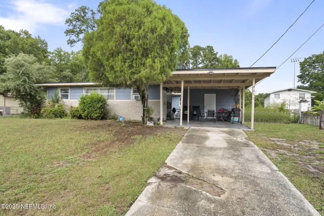 a view of a patio with table and chairs and potted plants