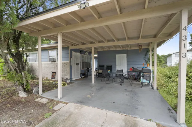 a view of front door and porch with furniture and a window