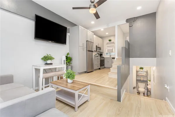 a living room with furniture and a flat screen tv