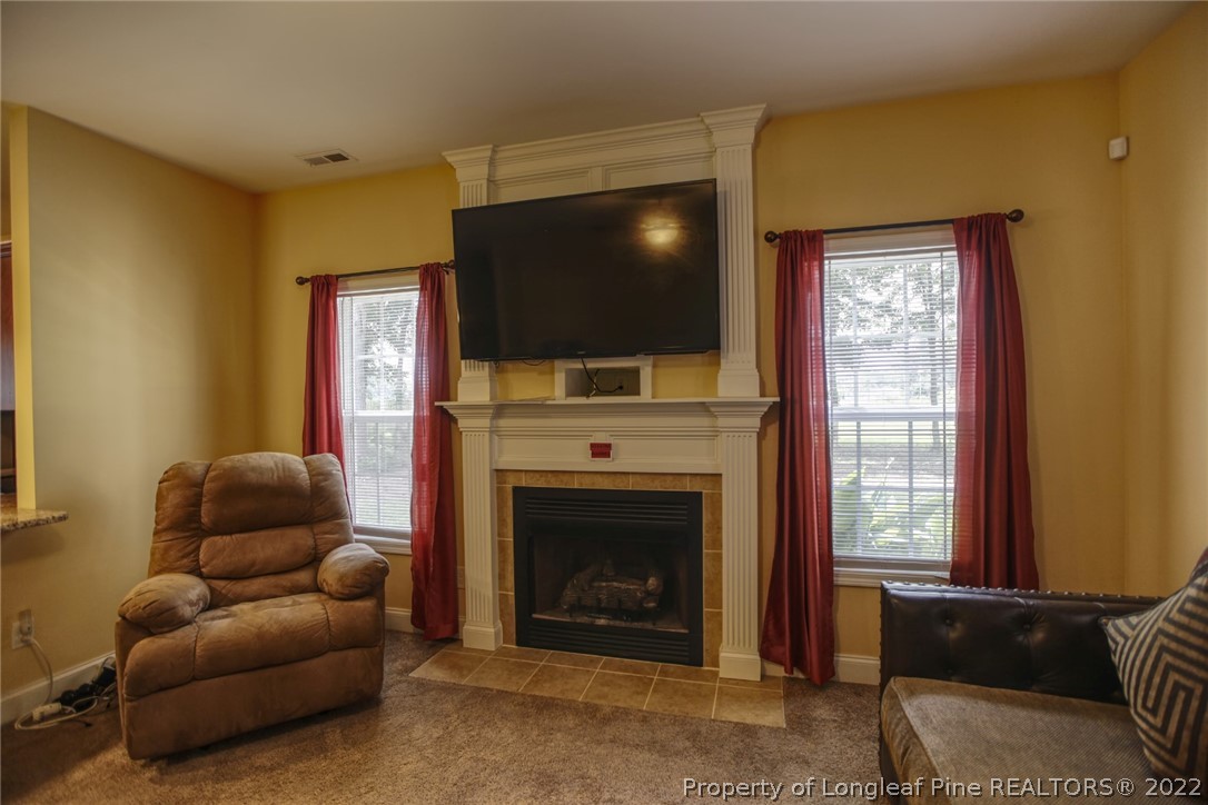 3548 Thrower Road Hope Mills, NC 28348 - Photo 4 of 22 a living room with furniture a flat screen tv and a fireplace