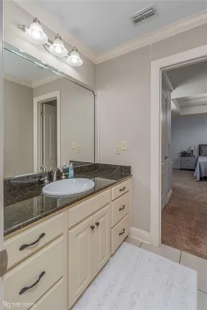 a bathroom with a granite countertop sink and a mirror