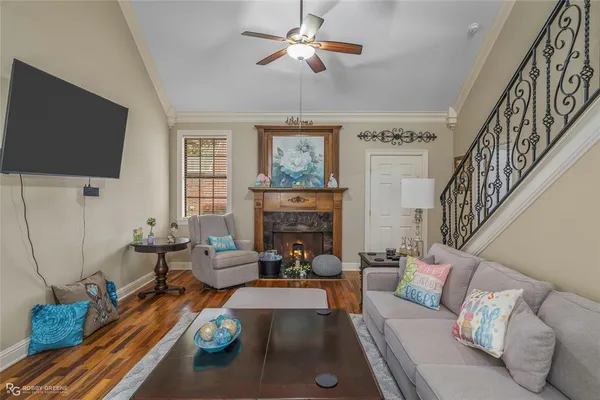 a living room with furniture a flat screen tv and a fireplace