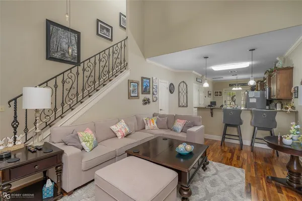 a living room with furniture and a dining table