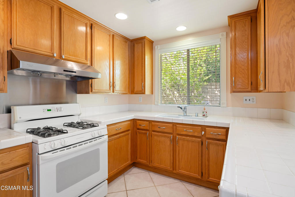 5657 Pansy Street Simi Valley, CA 93063 - Photo 11 of 32 a kitchen with granite countertop a sink stainless steel appliances and cabinets