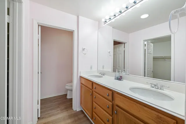 a bathroom with a double vanity sink and a mirror