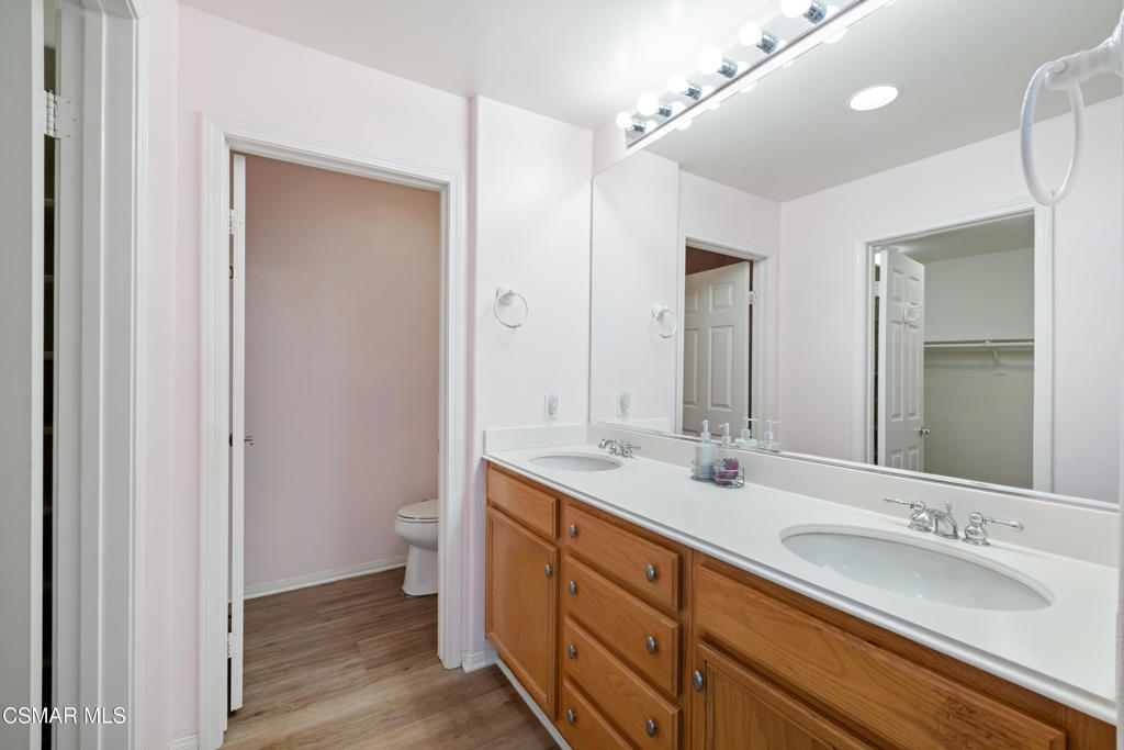 5657 Pansy Street Simi Valley, CA 93063 - Photo 16 of 32 a bathroom with a double vanity sink and a mirror