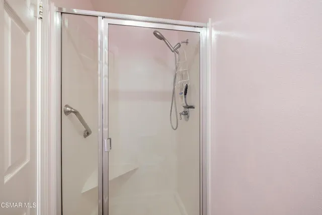 a bathroom with a glass shower door