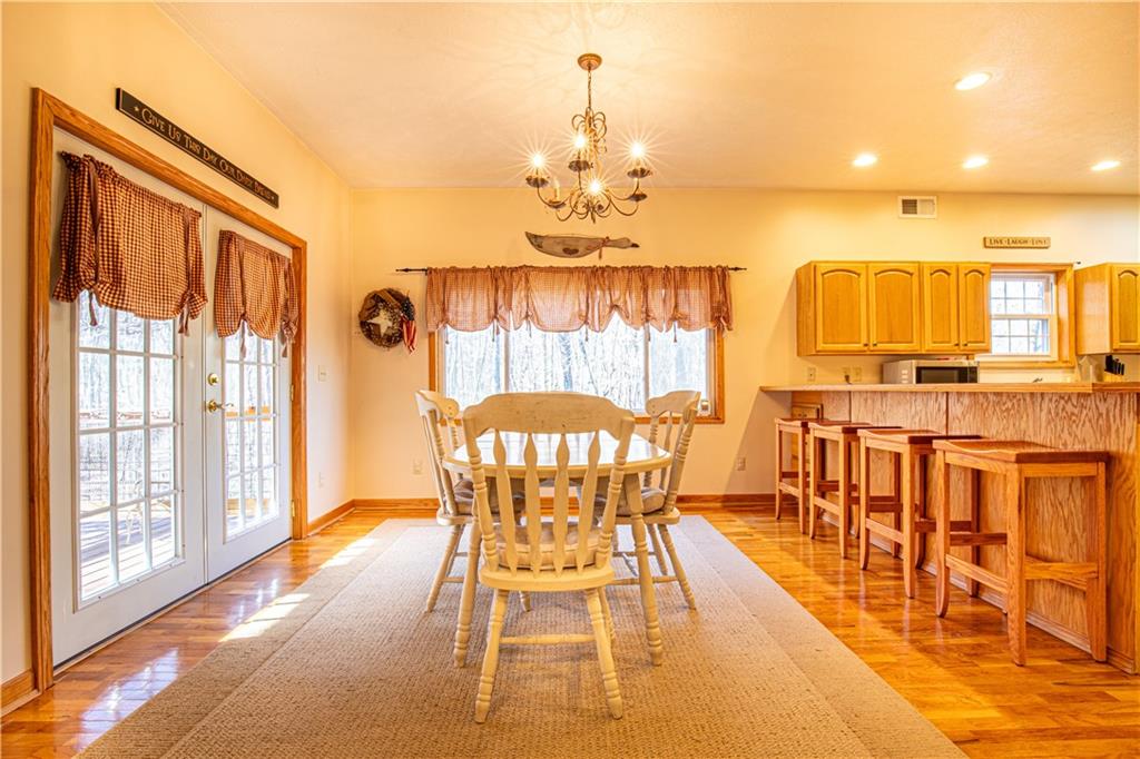 505 Greenbriar Road Dunbar, PA 15431 - Photo 15 of 43 a view of a dining room with furniture a chandelier and wooden floor