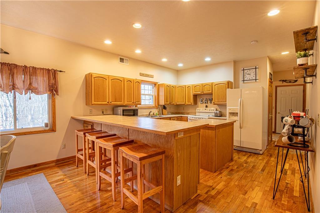 505 Greenbriar Road Dunbar, PA 15431 - Photo 10 of 43 a kitchen with stainless steel appliances granite countertop a sink a stove a refrigerator and island with wooden floor