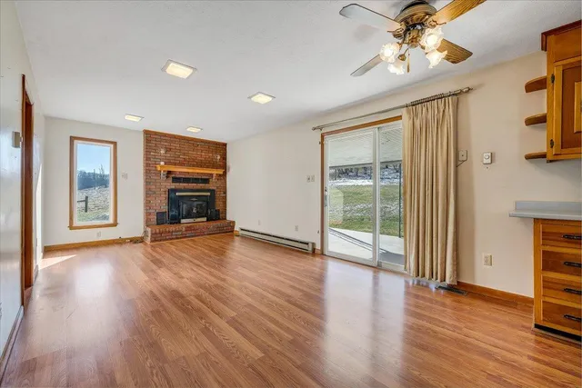 a kitchen with stainless steel appliances granite countertop a refrigerator a stove and a sink with wooden floor