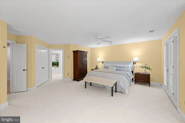 a spacious bedroom with a bed and a refrigerator