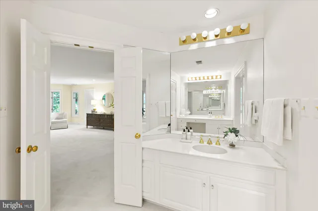 a bathroom with a sink vanity and a mirror