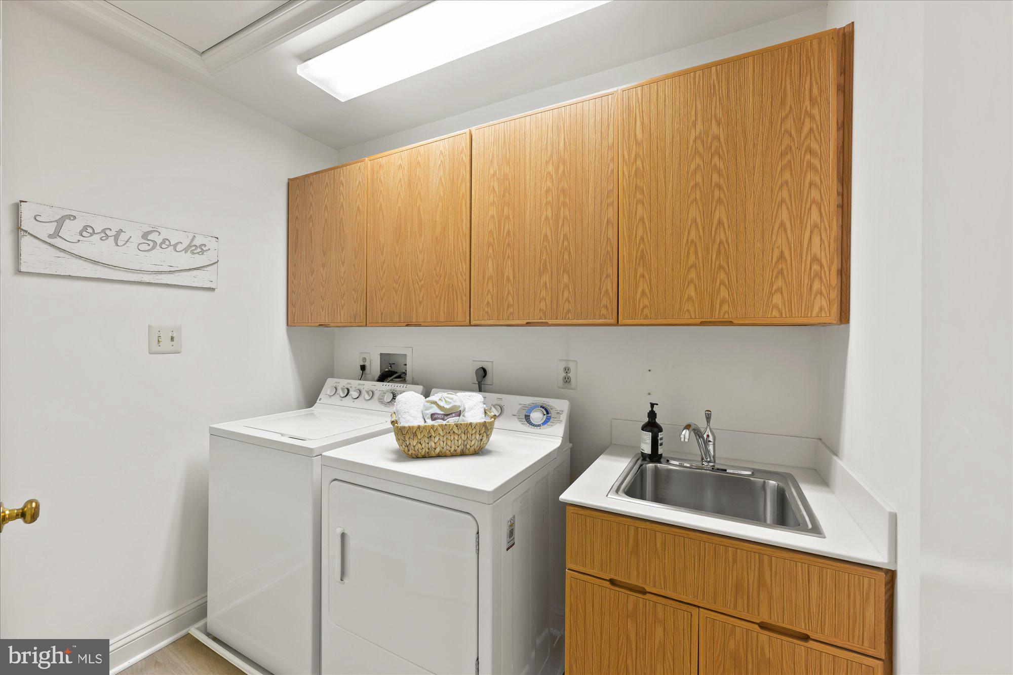 9729 Beman Woods Way Potomac, MD 20854 - Photo 28 of 41 a bathroom with a sink a washer and dryer