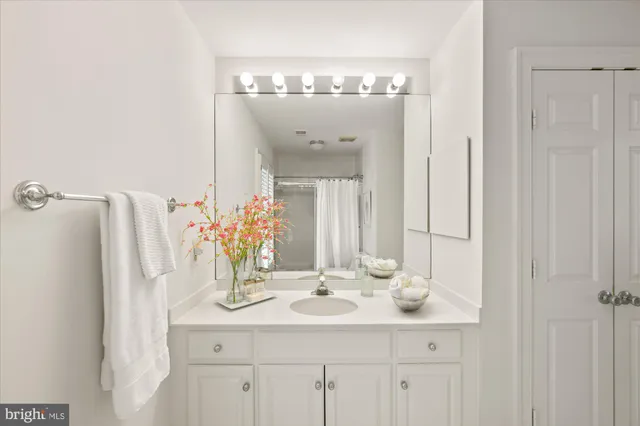 a bathroom with a sink vanity and a mirror