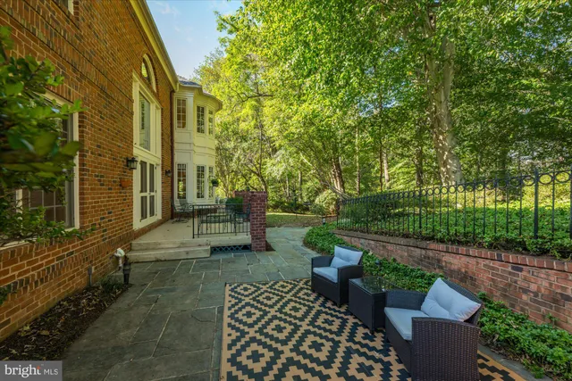 a view of a patio with table and chairs and potted plants