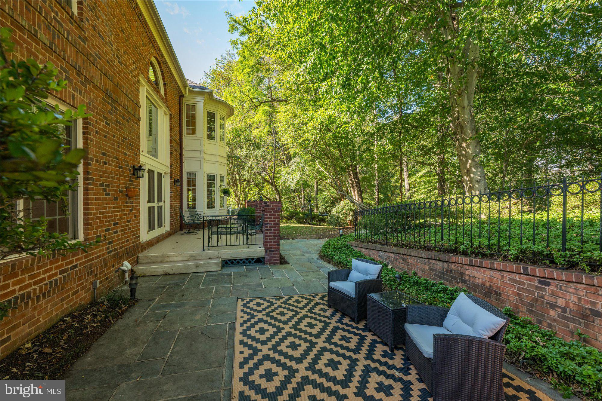 9729 Beman Woods Way Potomac, MD 20854 - Photo 39 of 41 a view of a patio with table and chairs and potted plants