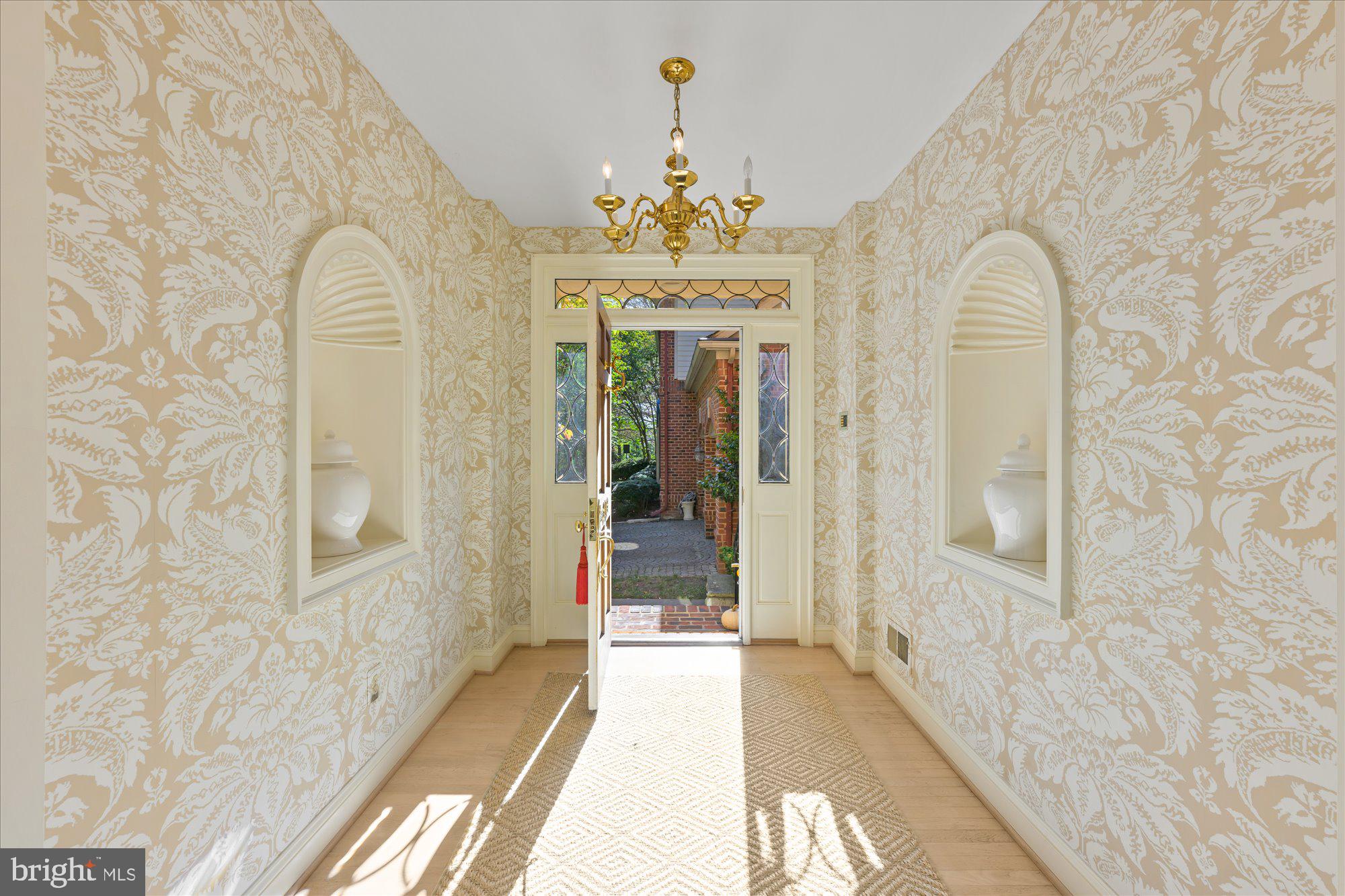 9729 Beman Woods Way Potomac, MD 20854 - Photo 4 of 41 a view of a hallway with wooden floor and chandelier