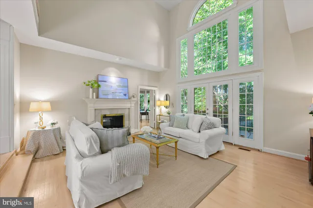 a living room with furniture a large window and a fireplace