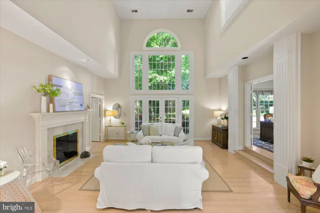 a living room with furniture a fireplace and a large window