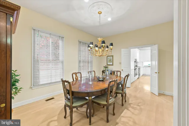 a view of a dining room with furniture and chandelier