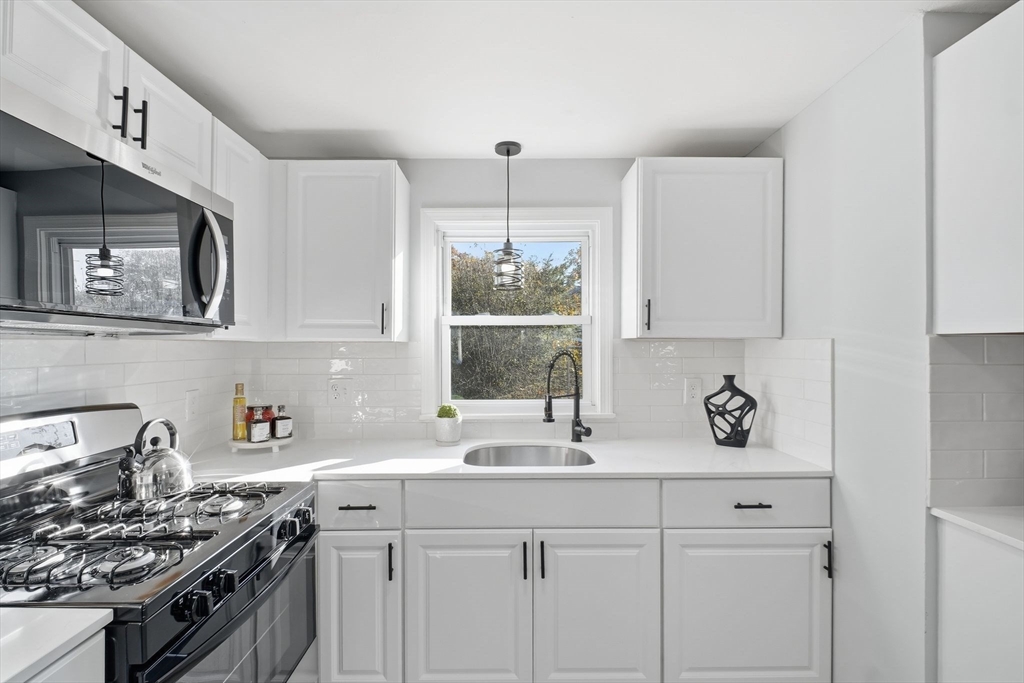 105 Denwall Drive Springfield, MA 01119 - Photo 11 of 29 a kitchen with stainless steel appliances a sink stove and cabinets