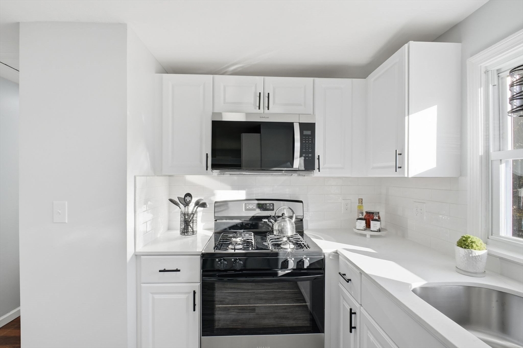 105 Denwall Drive Springfield, MA 01119 - Photo 13 of 29 a kitchen with sink a stove and cabinets