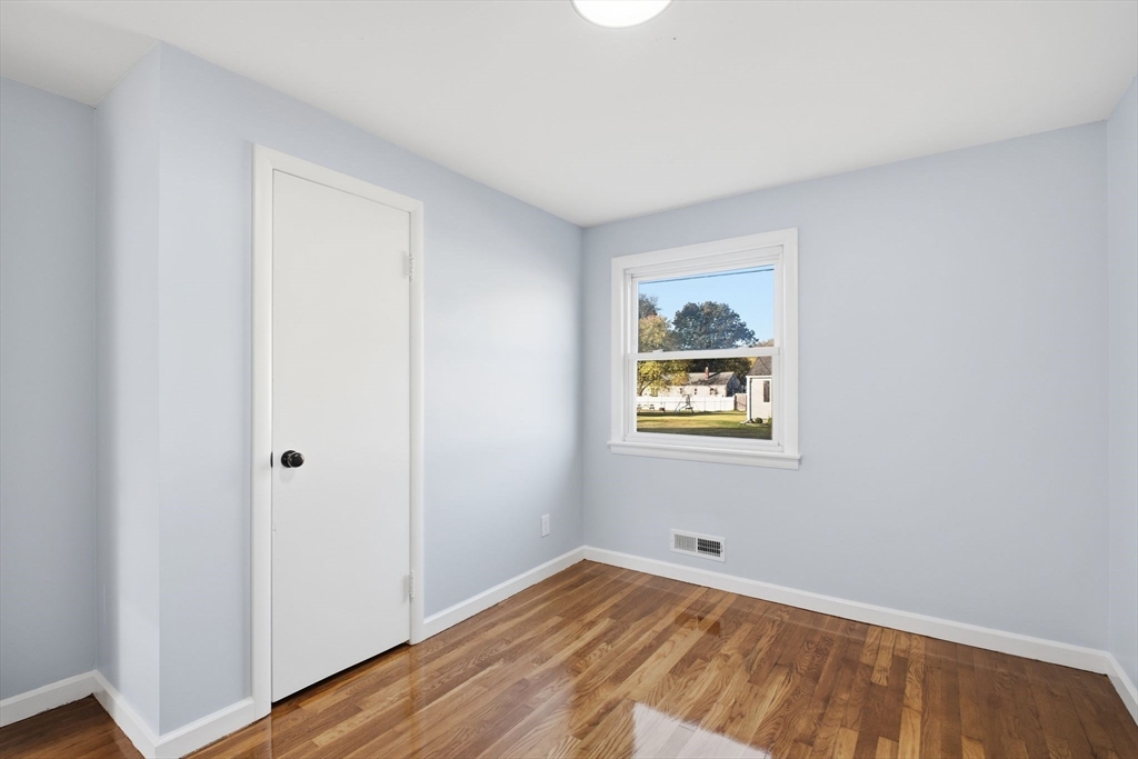 105 Denwall Drive Springfield, MA 01119 - Photo 19 of 29 a view of an empty room with wooden floor and a window