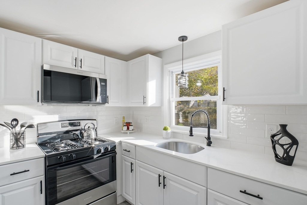 105 Denwall Drive Springfield, MA 01119 - Photo 9 of 29 a kitchen with stainless steel appliances a sink a stove and microwave