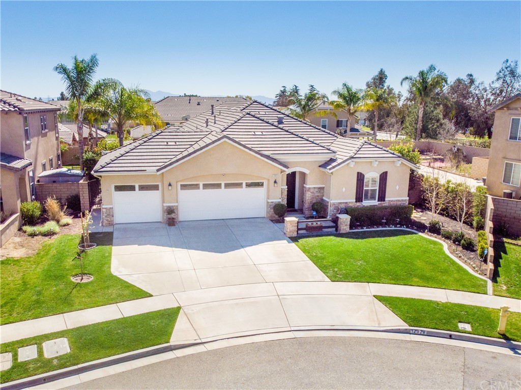 12929 Colonial Drive Rancho Cucamonga, CA 91739 - Photo 1 of 1 a front view of a house with a yard and garage