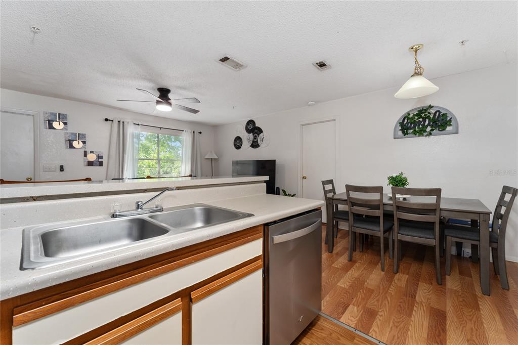 627 Dory Lane, Unit 304 Altamonte Springs, FL 32714 - Photo 19 of 28 a kitchen with a sink cabinets and dining table chair