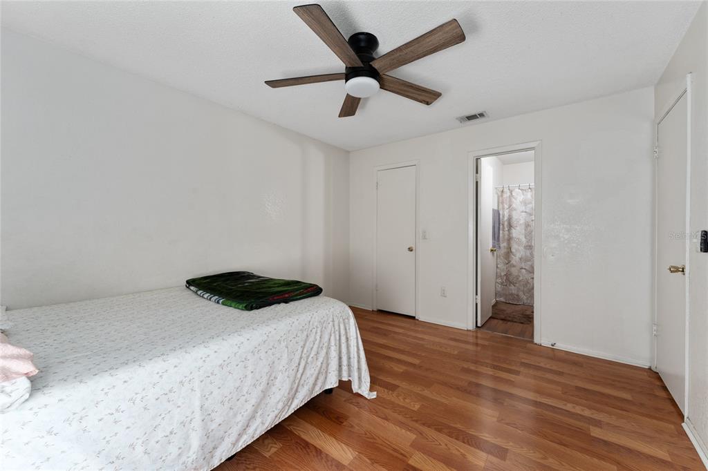 627 Dory Lane, Unit 304 Altamonte Springs, FL 32714 - Photo 21 of 28 a bedroom with a bed and a ceiling fan