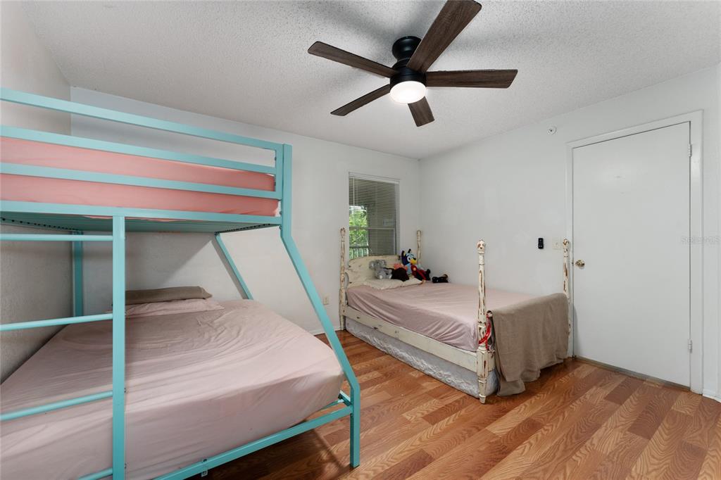 627 Dory Lane, Unit 304 Altamonte Springs, FL 32714 - Photo 27 of 28 a bedroom with a bed and a ceiling fan