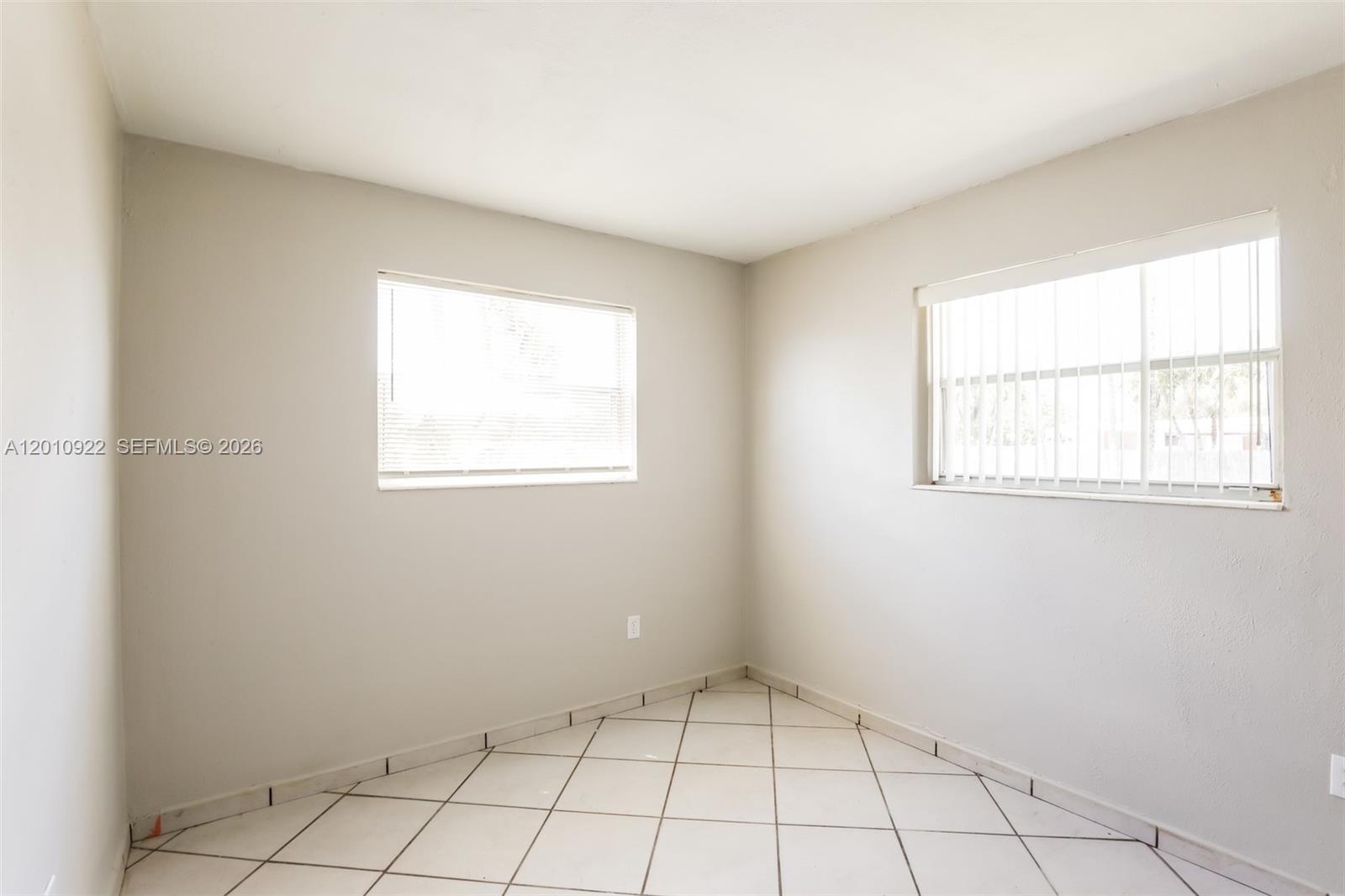 11460 Southwest 199th Street Miami, FL 33157 - Photo 12 of 18 a view of an empty room with a window
