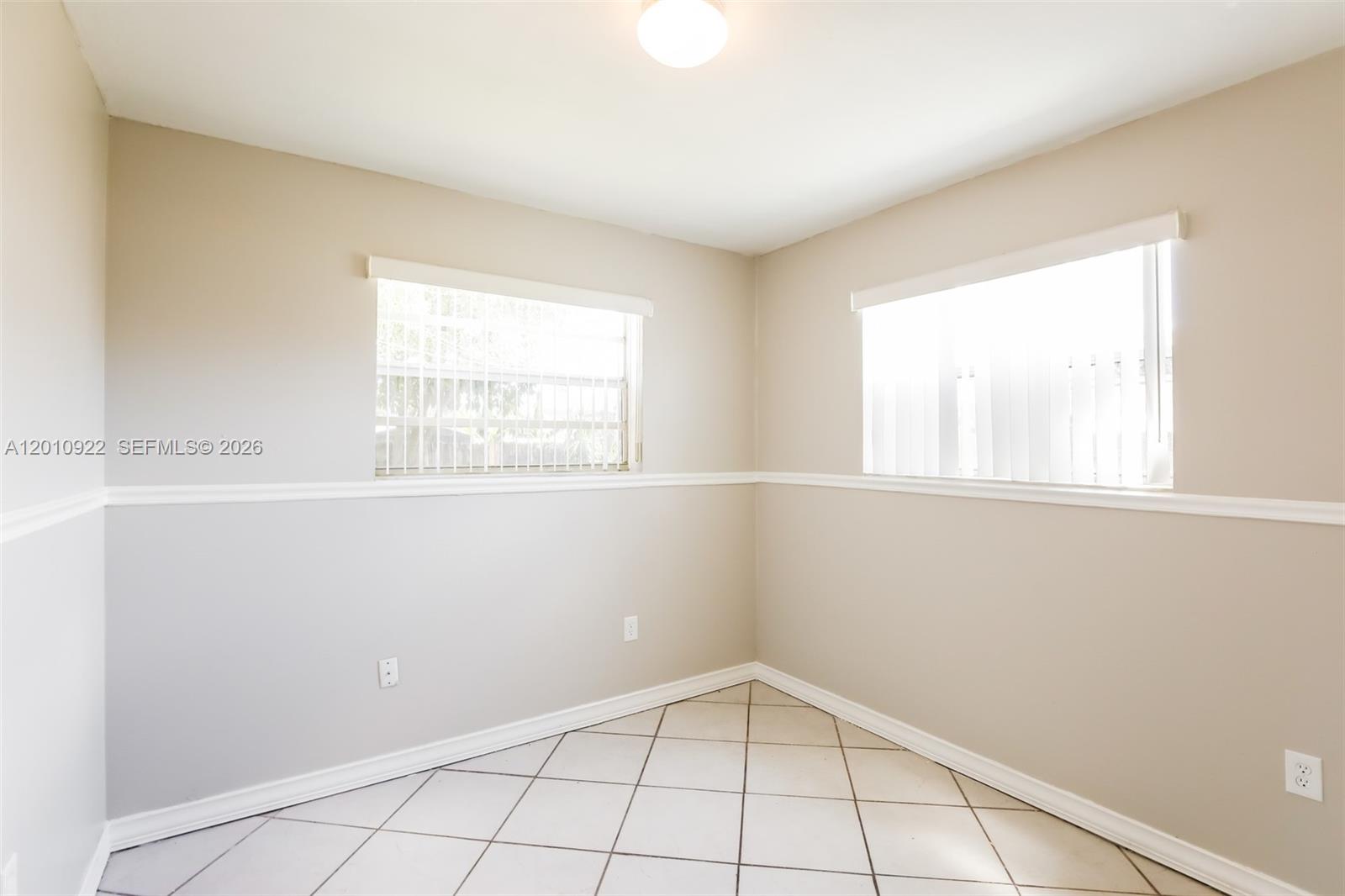 11460 Southwest 199th Street Miami, FL 33157 - Photo 14 of 18 a view of an empty room with a window