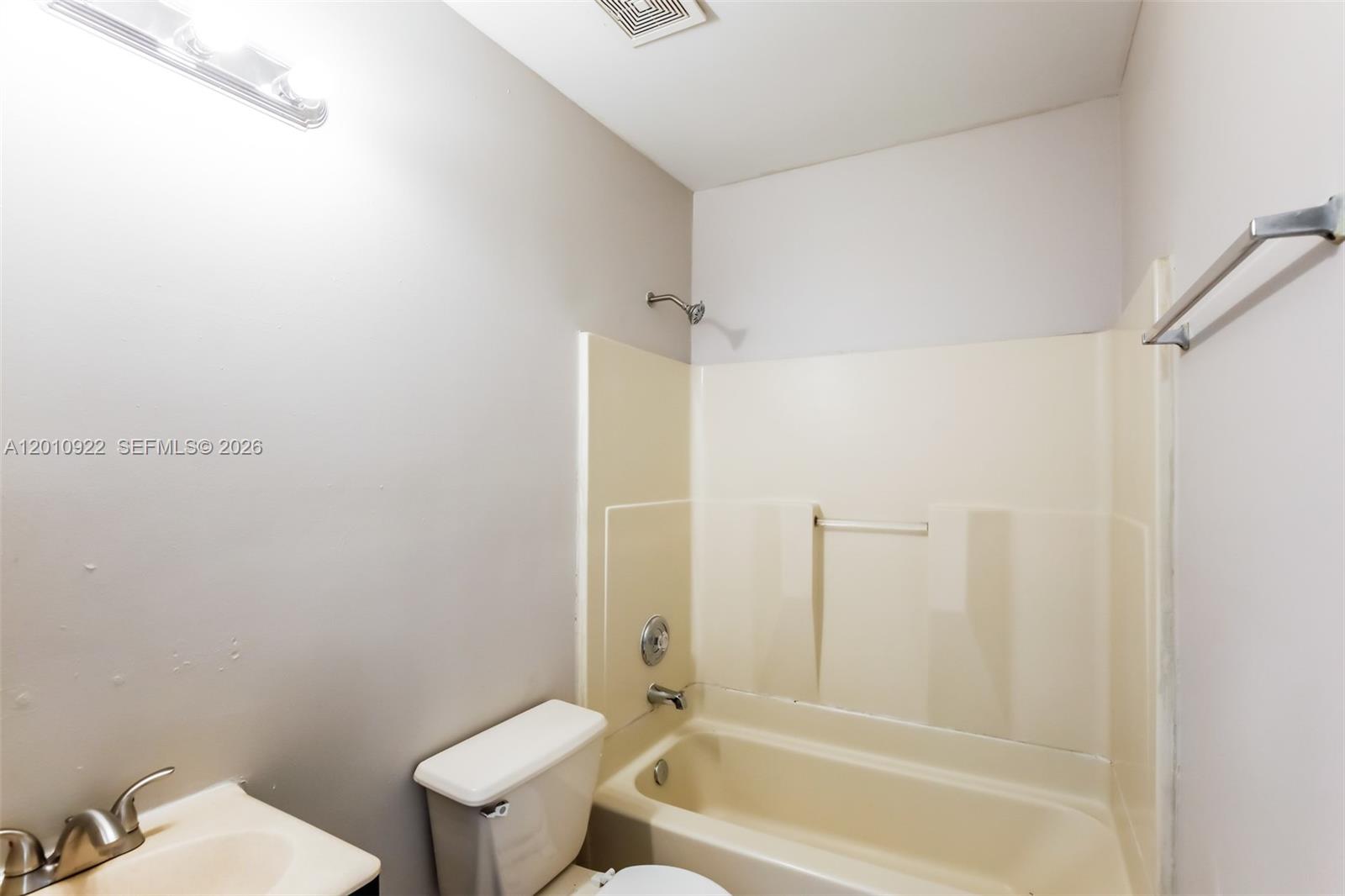 11460 Southwest 199th Street Miami, FL 33157 - Photo 16 of 18 a bathroom with a granite countertop toilet and a bathtub